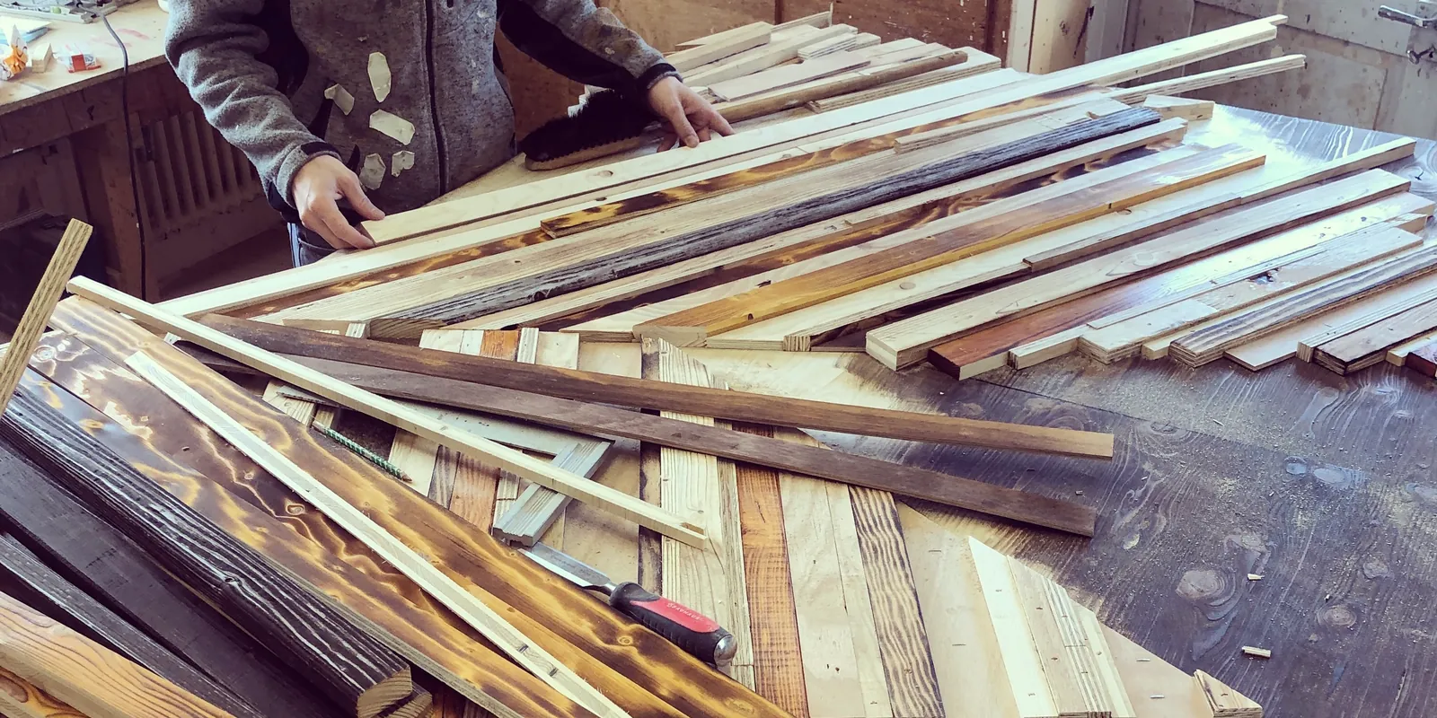 Holzleisten werden in der Werkstatt zu einem Muster gelegt